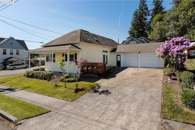 420 Bryant St, Clatskanie, OR 97016 - view of front facade featuring concrete driveway, a garage, a front yard, a shingled roof, and a porch