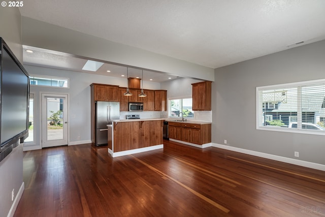 420 Bryant St, Clatskanie, OR 97016 - kitchen with appliances with stainless steel finishes, dark wood-style flooring, a sink, light countertops, and a kitchen island