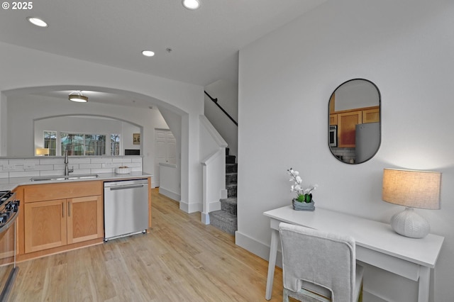 742 NW 118th Ave Unit 102, Portland, OR 97229 - kitchen featuring dishwasher, arched walkways, light wood-type flooring, recessed lighting, and backsplash