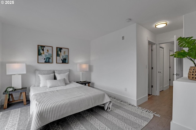 742 NW 118th Ave Unit 102, Portland, OR 97229 - bedroom with baseboards and wood finished floors