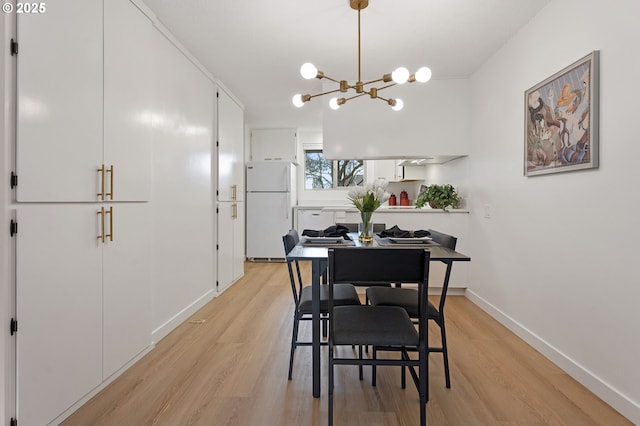 dining space featuring a chandelier and light hardwood / wood-style floors