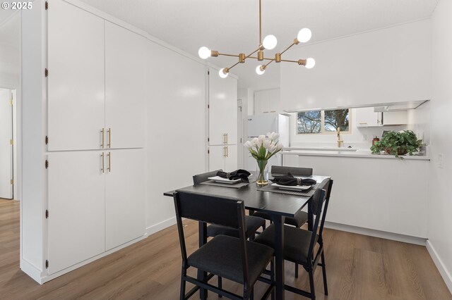 dining room with hardwood / wood-style flooring and a notable chandelier