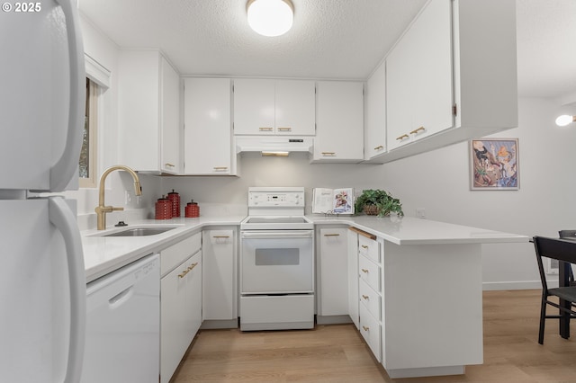 kitchen with sink, white appliances, white cabinets, kitchen peninsula, and light wood-type flooring