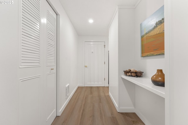 hallway with light hardwood / wood-style flooring