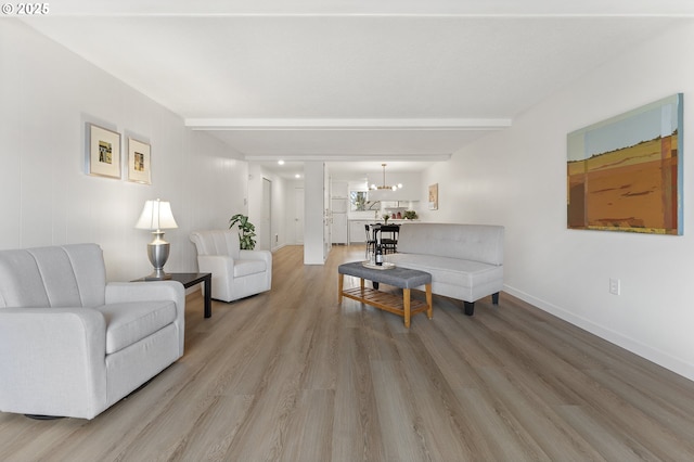 living room with hardwood / wood-style flooring and a chandelier