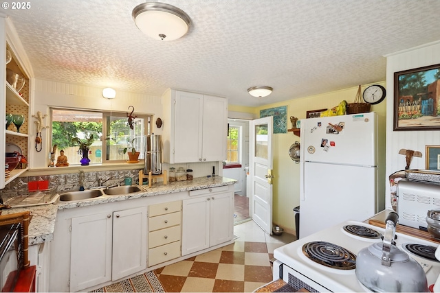 317 E 14th St, The Dalles, OR 97058 - kitchen with white appliances, light flooring, a sink, white cabinets, and a textured ceiling