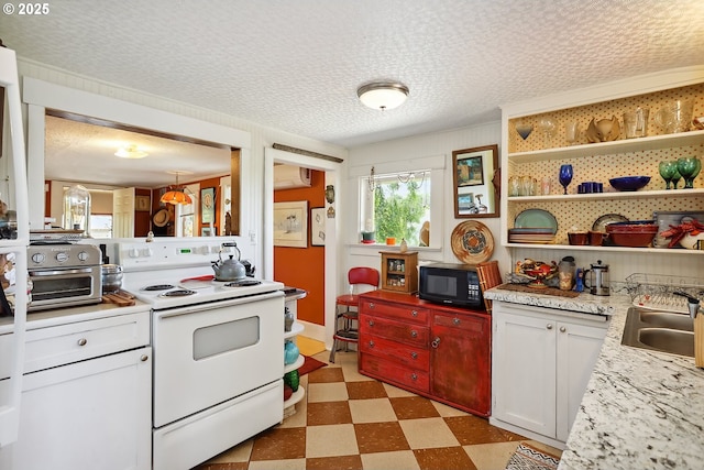 317 E 14th St, The Dalles, OR 97058 - kitchen with electric range, black microwave, light flooring, a sink, and light countertops