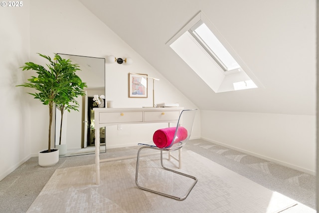 interior space featuring lofted ceiling with skylight, baseboards, and carpet