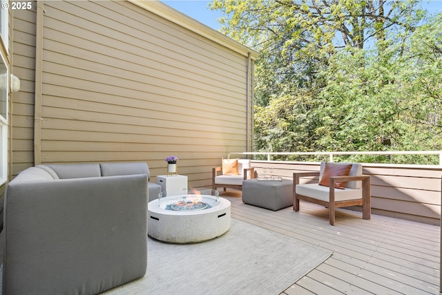 wooden terrace featuring a fire pit