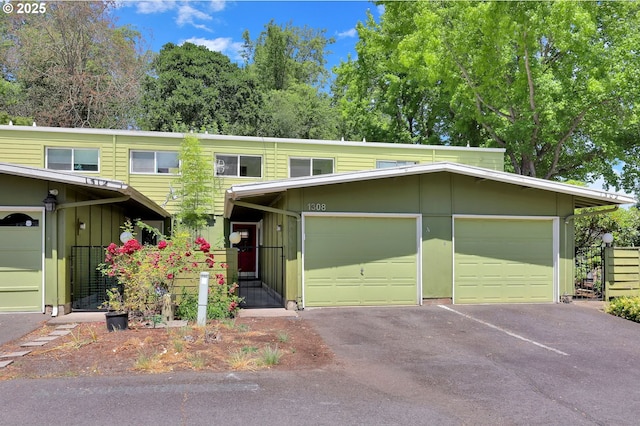 1308 Quaker St, Eugene, OR 97402 - view of property with driveway, a garage, and board and batten siding