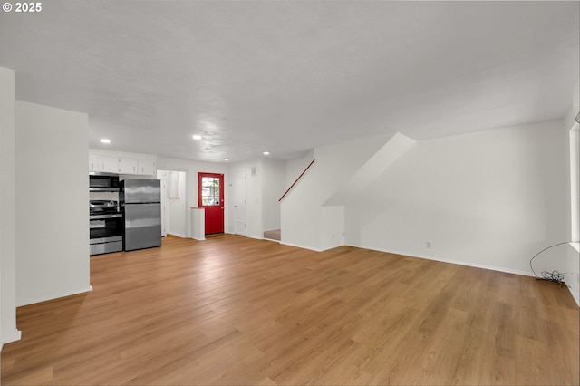 1308 Quaker St, Eugene, OR 97402 - unfurnished living room featuring recessed lighting, light wood-type flooring, and stairway