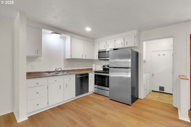 1308 Quaker St, Eugene, OR 97402 - kitchen with stainless steel appliances, light wood-style floors, white cabinets, dark countertops, and recessed lighting