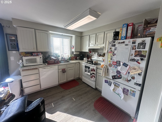 kitchen featuring sink, dark wood-type flooring, white cabinets, and white appliances