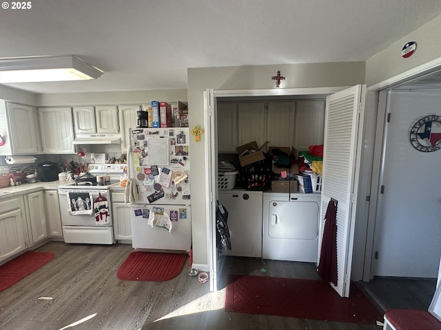 kitchen featuring white appliances, dark wood-type flooring, washing machine and dryer, and white cabinets