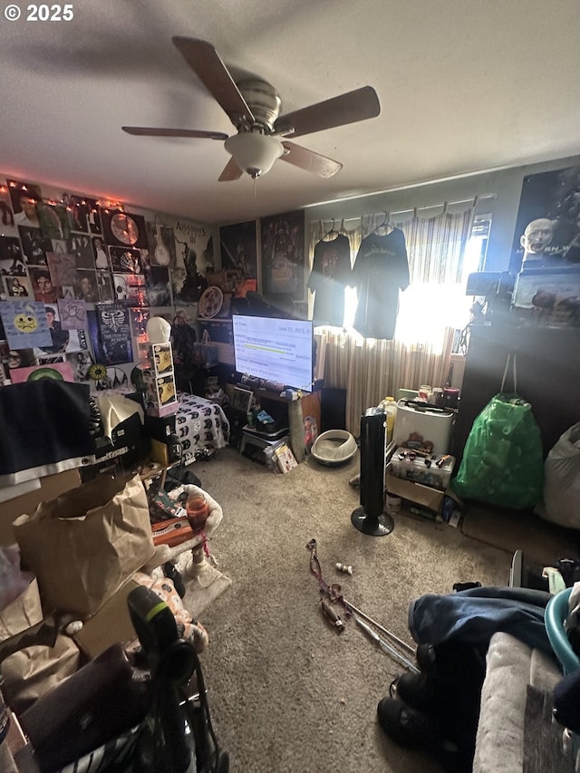 interior space featuring ceiling fan and carpet floors