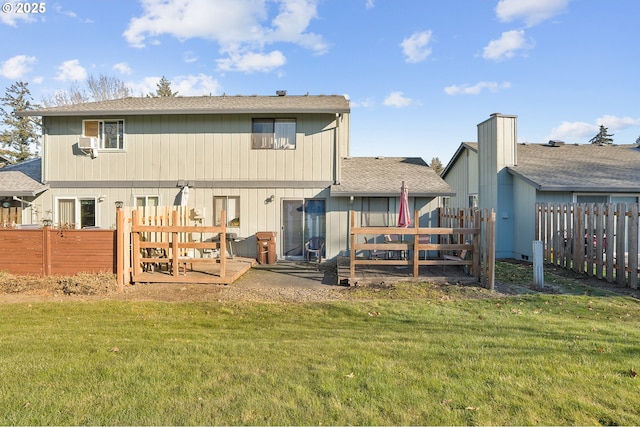 rear view of property with a lawn