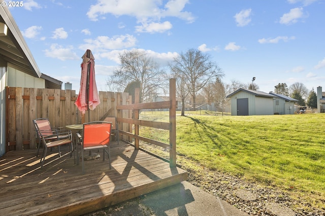 wooden deck with an outbuilding and a yard