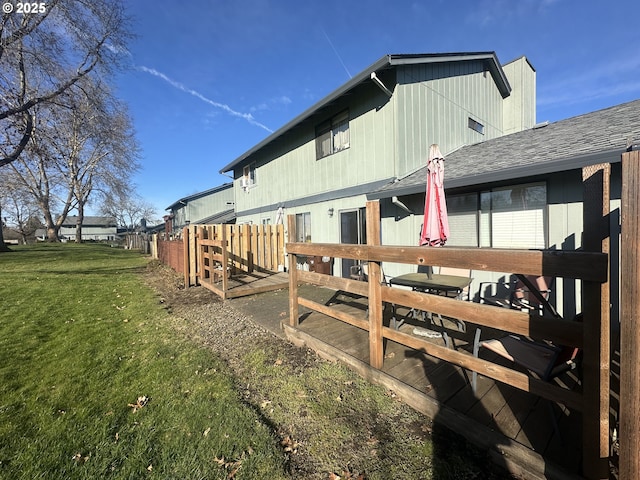 view of side of home with a yard