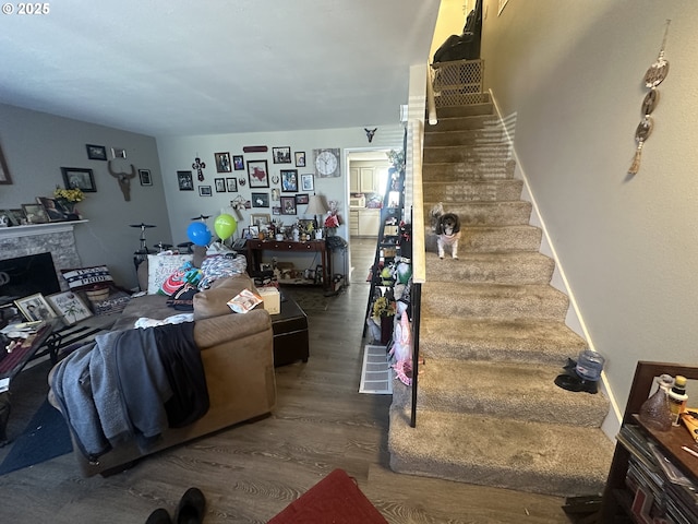 living room with a fireplace and dark hardwood / wood-style floors