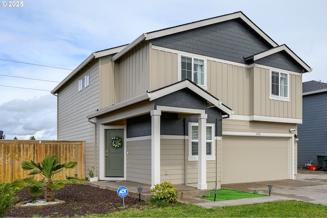 view of front of property with an attached garage, fence, and board and batten siding