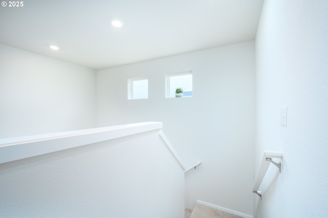 stairway with carpet floors and recessed lighting