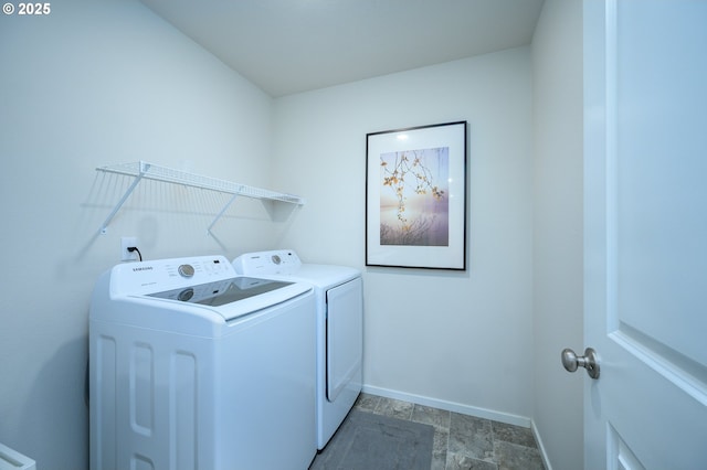 clothes washing area featuring laundry area, baseboards, and independent washer and dryer