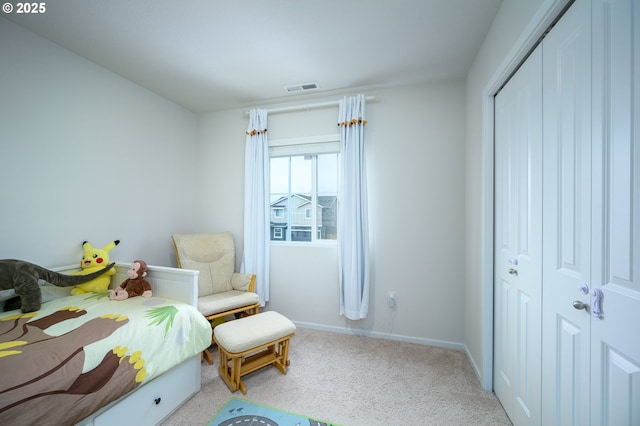 bedroom featuring light colored carpet, a closet, visible vents, and baseboards