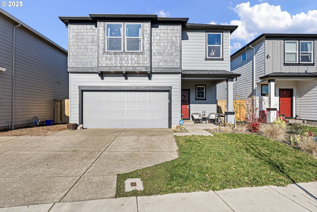 view of front property featuring a garage and a front lawn