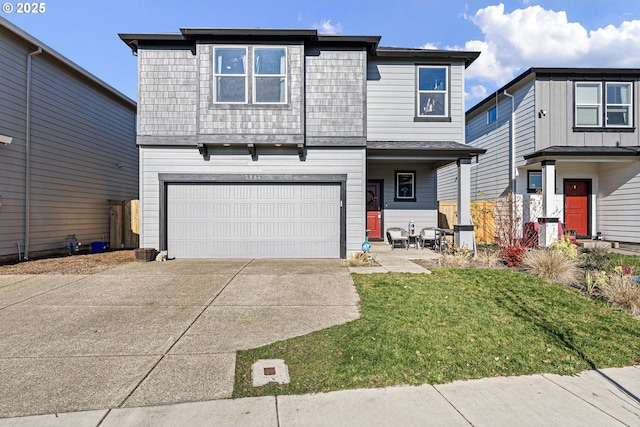 view of front property featuring a garage and a front lawn