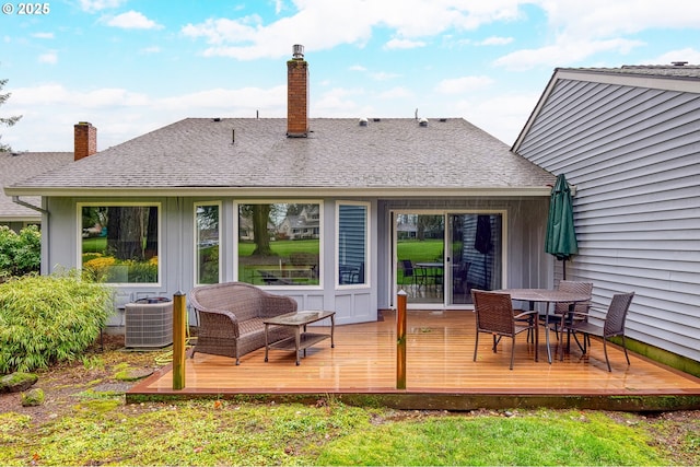 rear view of house with a wooden deck and central AC