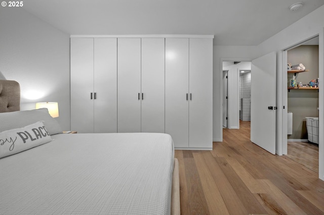 bedroom featuring light wood-type flooring and baseboards