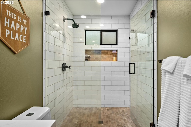 full bathroom featuring a stall shower, a textured wall, and toilet