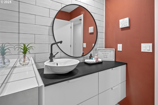 bathroom with tasteful backsplash and vanity