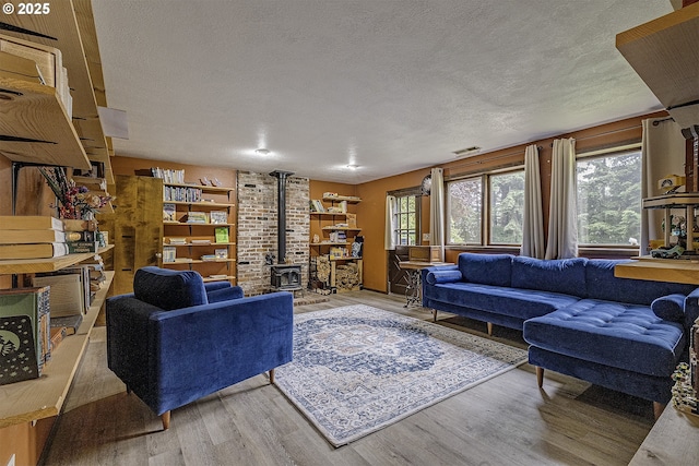 21445 NE Ornduff Rd, Hillsboro, OR 97123 - living area featuring a wood stove, wood finished floors, and a textured ceiling