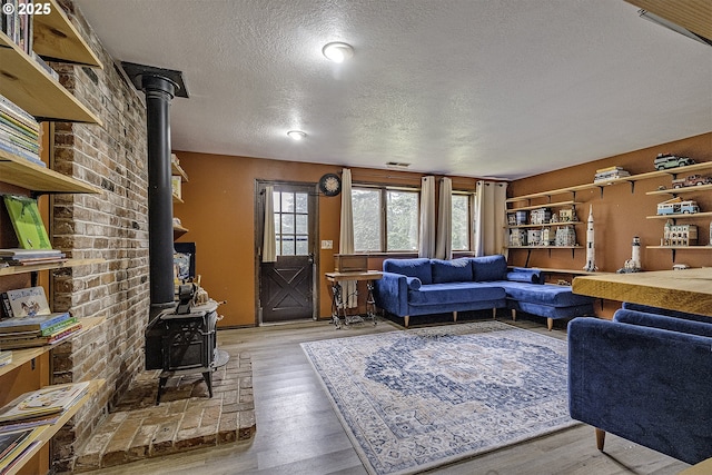 21445 NE Ornduff Rd, Hillsboro, OR 97123 - living room featuring a wood stove, a textured ceiling, and wood finished floors