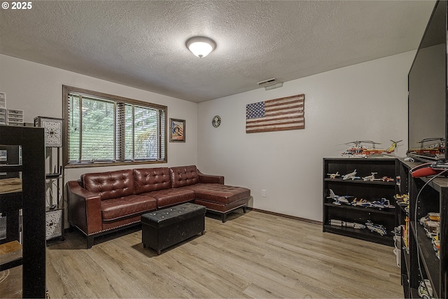 21445 NE Ornduff Rd, Hillsboro, OR 97123 - living area featuring light wood finished floors, a textured ceiling, and baseboards