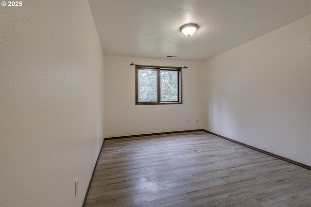21445 NE Ornduff Rd, Hillsboro, OR 97123 - empty room with wood finished floors and baseboards