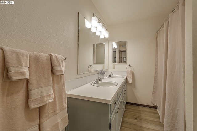 21445 NE Ornduff Rd, Hillsboro, OR 97123 - bathroom with wood finished floors, double vanity, and baseboards