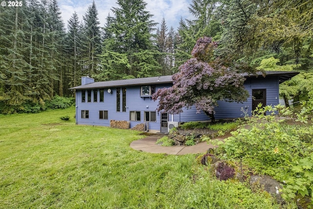 21445 NE Ornduff Rd, Hillsboro, OR 97123 - back of property featuring a yard, a chimney, and a view of trees