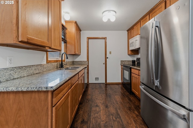 3116 NE 108th Ave, Portland, OR 97220 - kitchen featuring stainless steel appliances, a sink, dark wood-style floors, brown cabinets, and stone counters