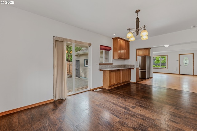 3116 NE 108th Ave, Portland, OR 97220 - kitchen featuring freestanding refrigerator, a chandelier, brown cabinets, dark wood-style floors, and decorative light fixtures