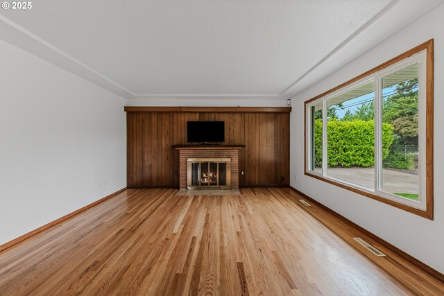 3116 NE 108th Ave, Portland, OR 97220 - unfurnished living room with light wood-style flooring, a fireplace, and baseboards