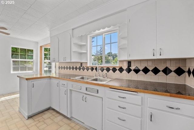 161 1st St, Dillard, OR 97432 - kitchen featuring open shelves, a sink, decorative backsplash, white cabinetry, and a peninsula