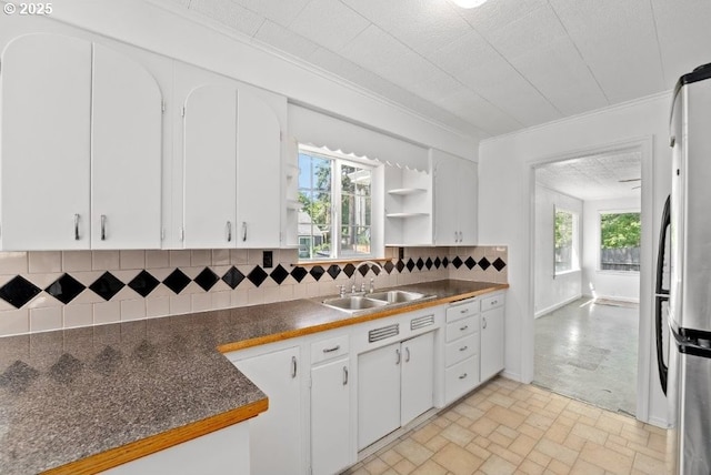 161 1st St, Dillard, OR 97432 - kitchen featuring freestanding refrigerator, dark countertops, a sink, healthy amount of natural light, and crown molding