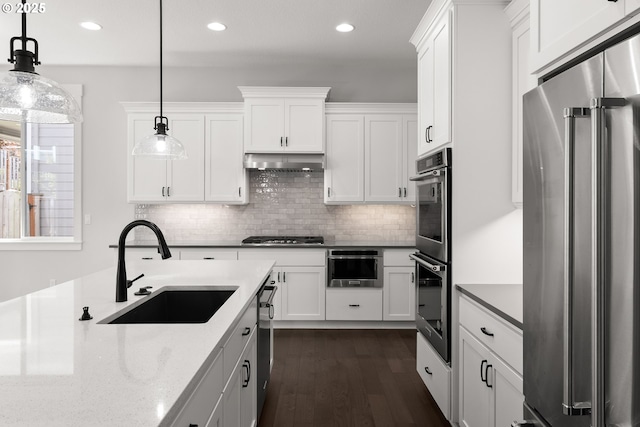 16706 NW Crossvine St, Portland, OR 97229 - kitchen with appliances with stainless steel finishes, a sink, white cabinetry, dark wood-type flooring, and recessed lighting