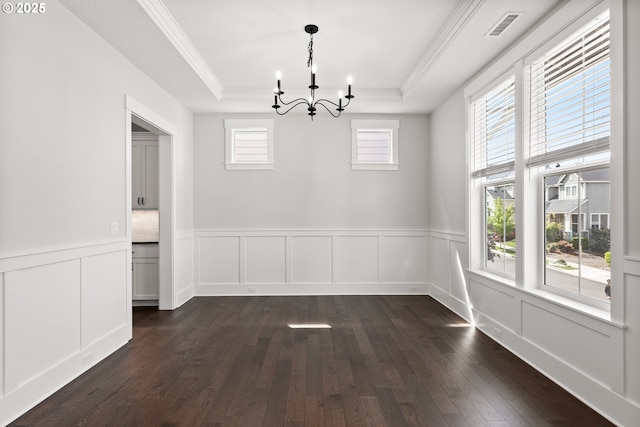 16706 NW Crossvine St, Portland, OR 97229 - unfurnished dining area featuring a raised ceiling, a chandelier, dark wood-type flooring, a decorative wall, and a wainscoted wall