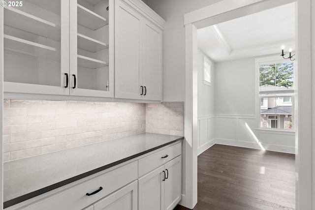 16706 NW Crossvine St, Portland, OR 97229 - kitchen featuring dark wood-type flooring, crown molding, white cabinets, glass insert cabinets, and a wainscoted wall
