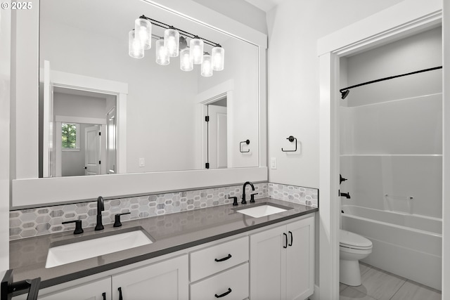 16706 NW Crossvine St, Portland, OR 97229 - full bathroom with decorative backsplash, double vanity, toilet, and shower / washtub combination