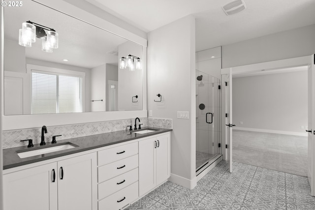 16706 NW Crossvine St, Portland, OR 97229 - bathroom with a shower stall, double vanity, baseboards, and backsplash