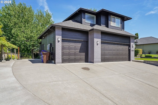 view of front facade with brick siding, driveway, and a garage